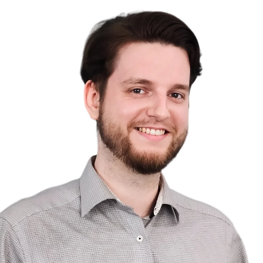 Rafal Rohde, smiling, in a grey checked shirt